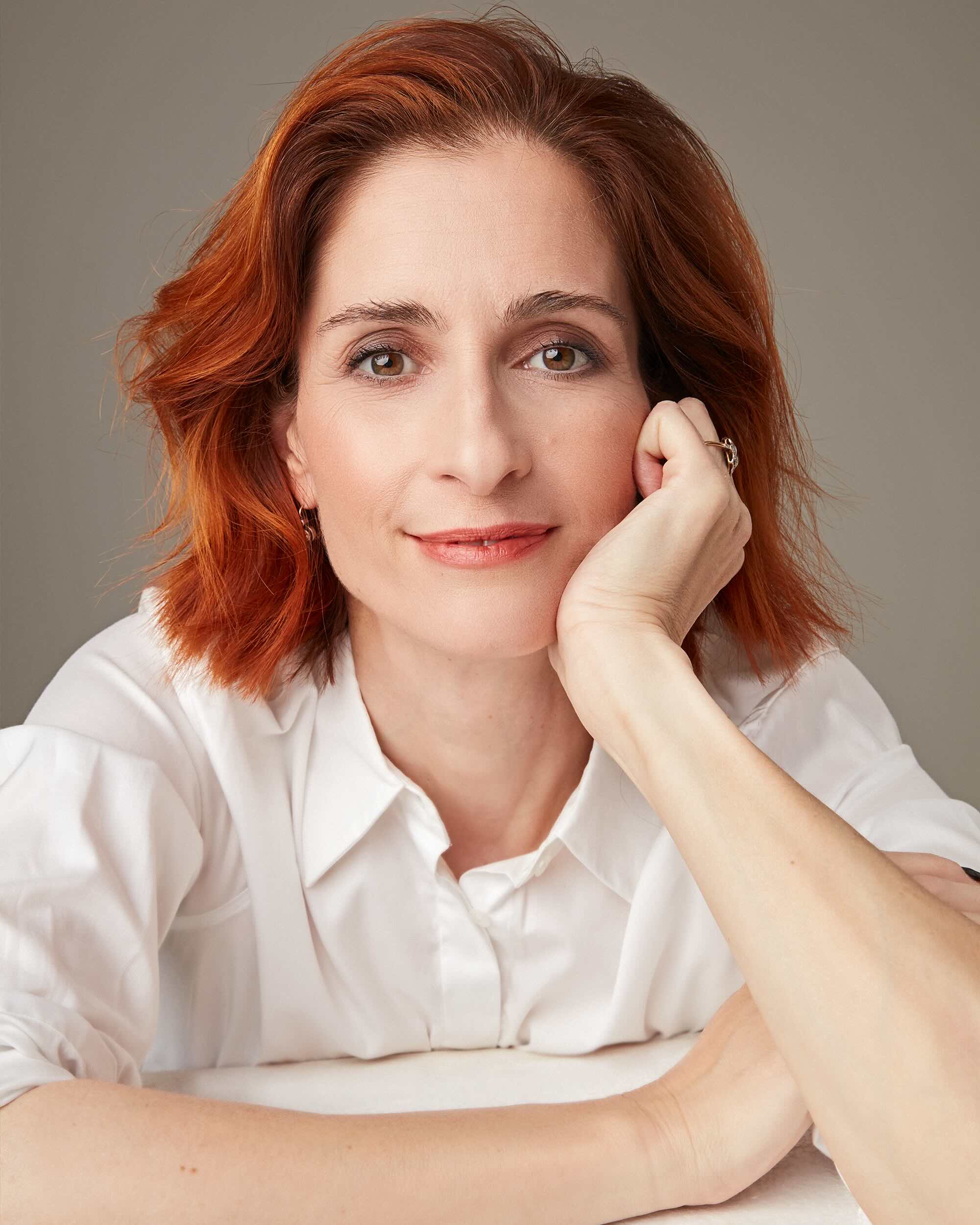 Barbara headshot on a beige background.